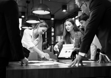 A Female Business Development Leader having a project status meeting or decision to report, analyze and improve to increases team's overall productivity in a tech business office.