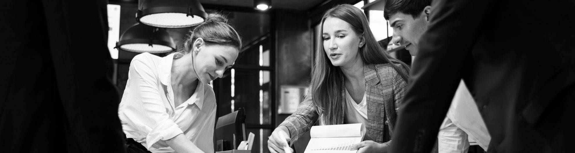 A Female Business Development Leader having a project status meeting or decision to report, analyze and improve to increases team's overall productivity in a tech business office.